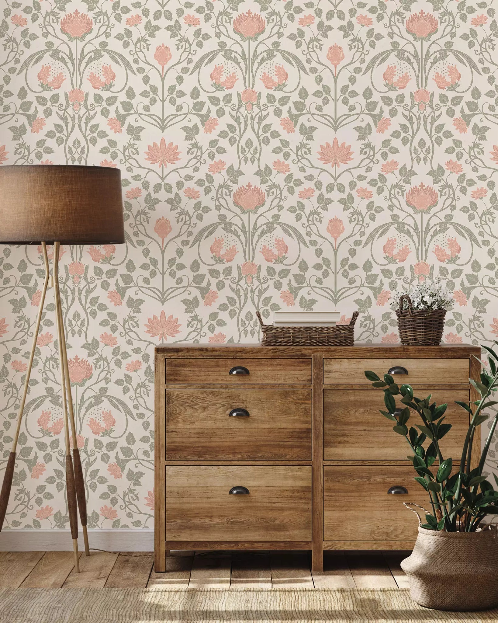 Wooden dresser with floral wallpaper and a lamp in a room setting