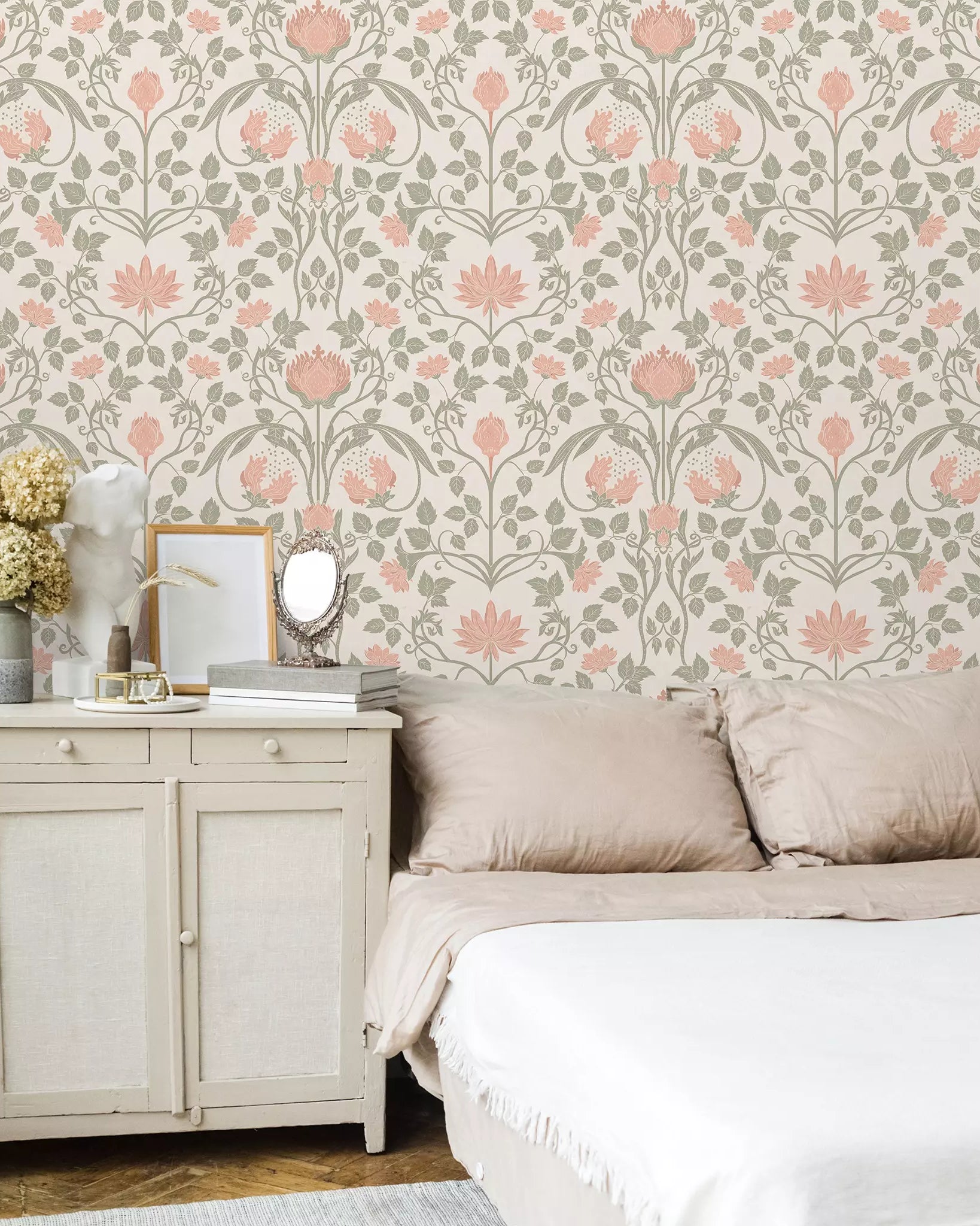 Bedroom with floral wallpaper, bed, and side table.