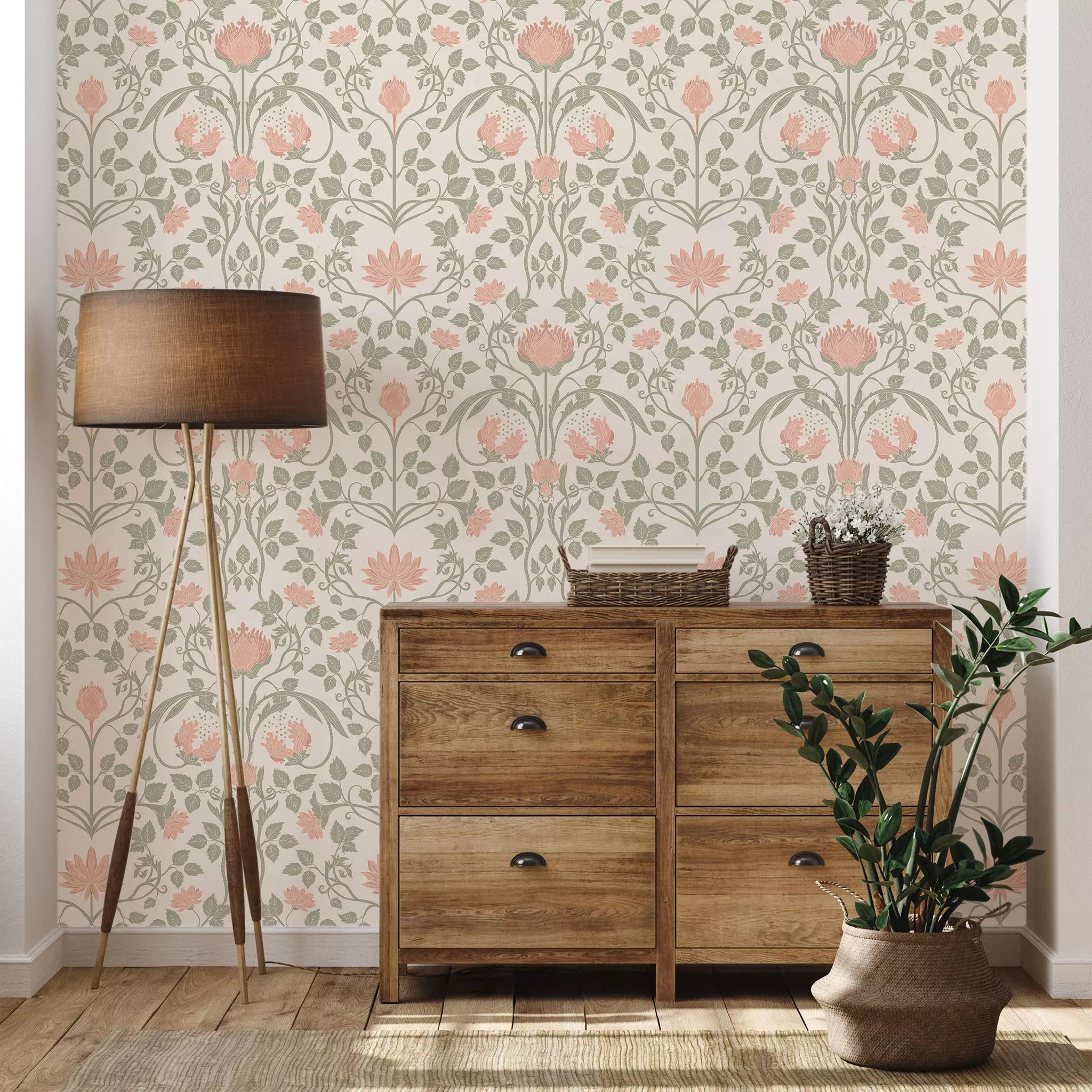 Wooden dresser with floral wallpaper and a lamp in a room setting